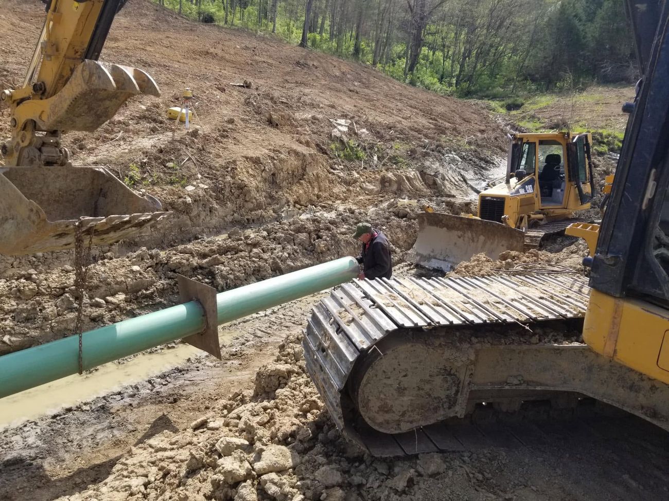 Large diameter pipe being set into an open trench